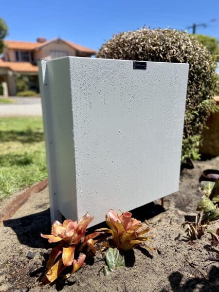 Full home filtration system mounted on a wall outside of a house0001